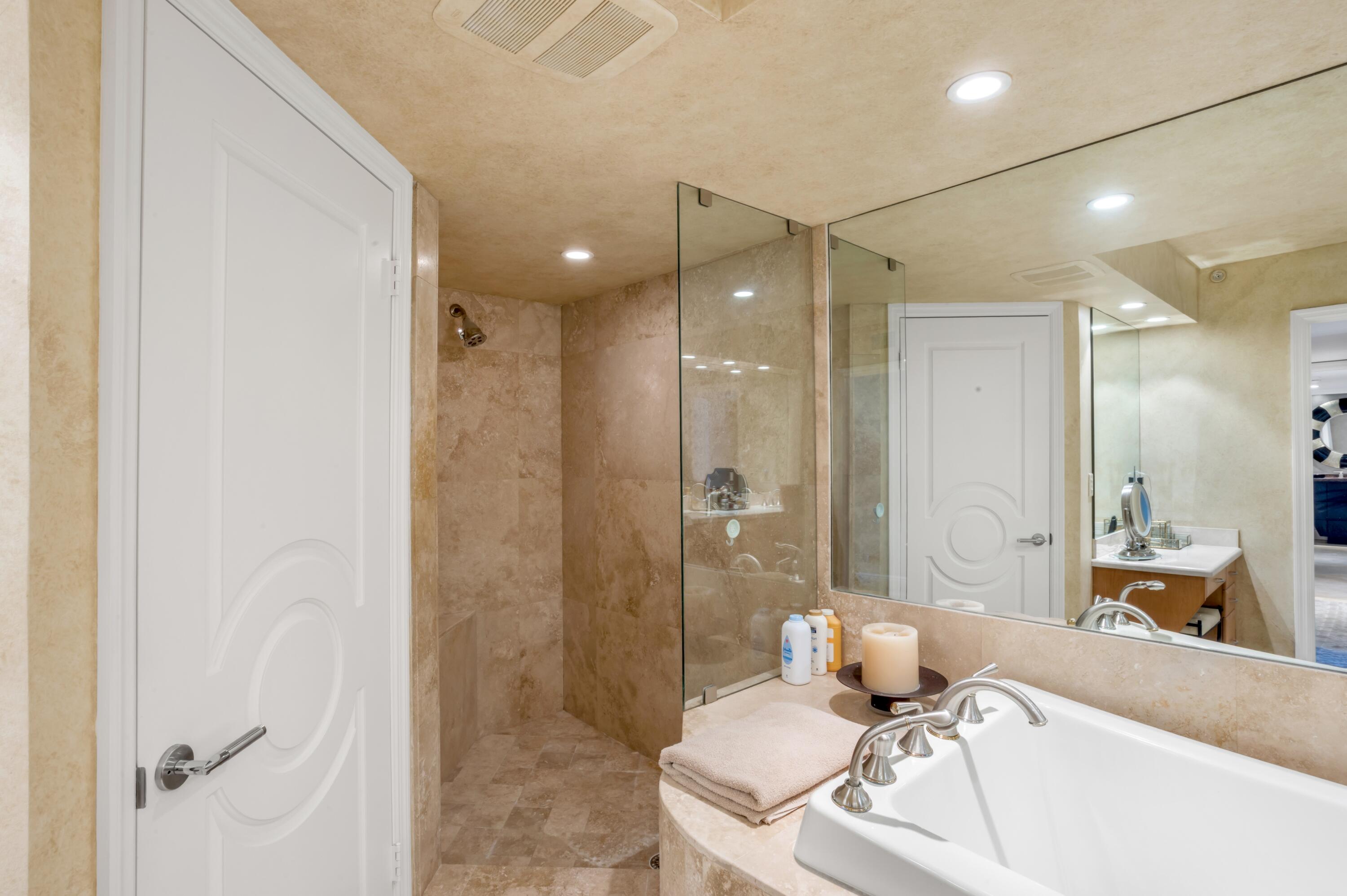 901 East Camino Real, Unit 7C Boca Raton, FL 33432 - Photo 27 of 41 a bathroom with a granite countertop sink mirror and a shower