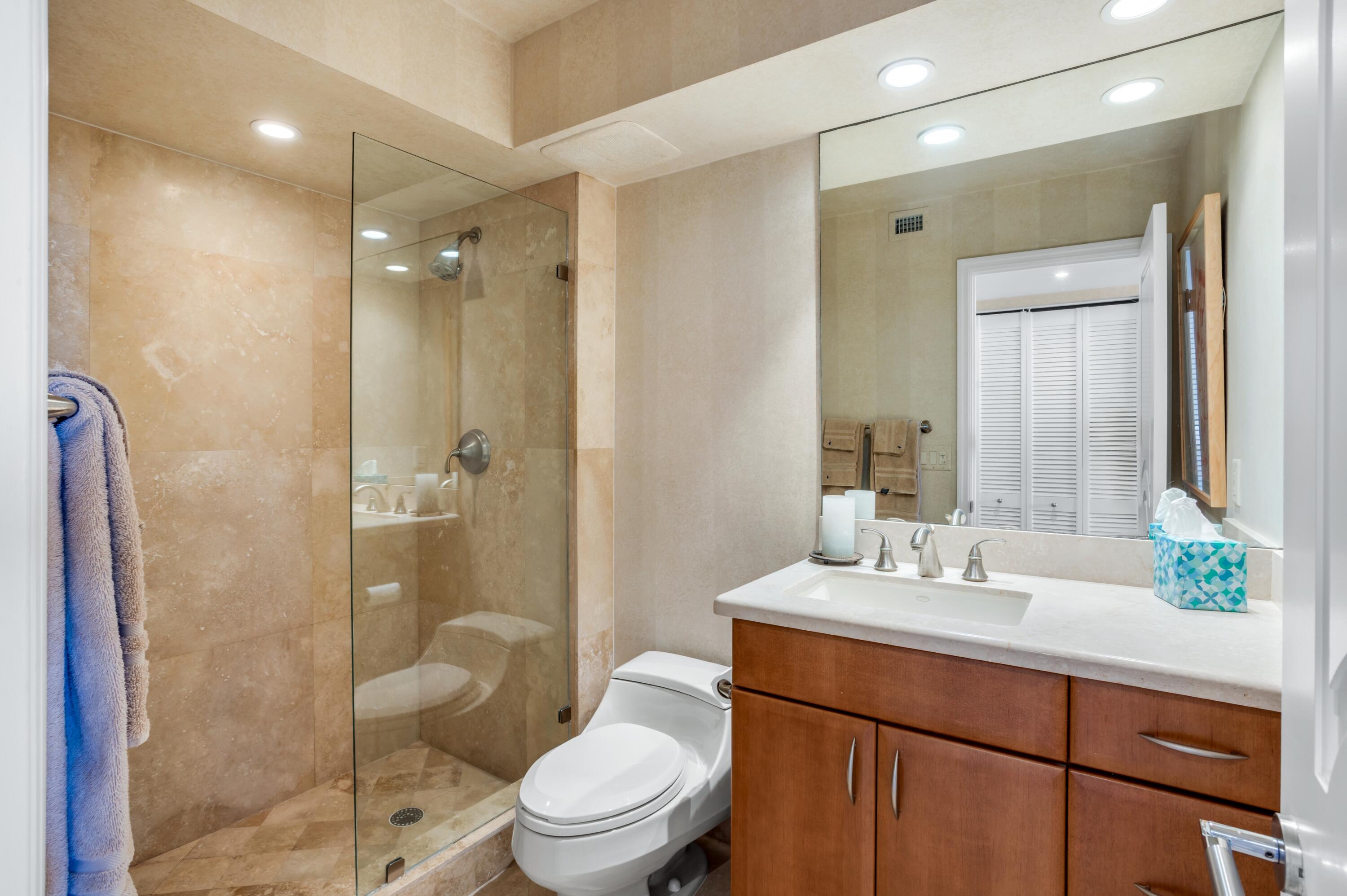 901 East Camino Real, Unit 7C Boca Raton, FL 33432 - Photo 29 of 41 a bathroom with a sink a toilet and shower