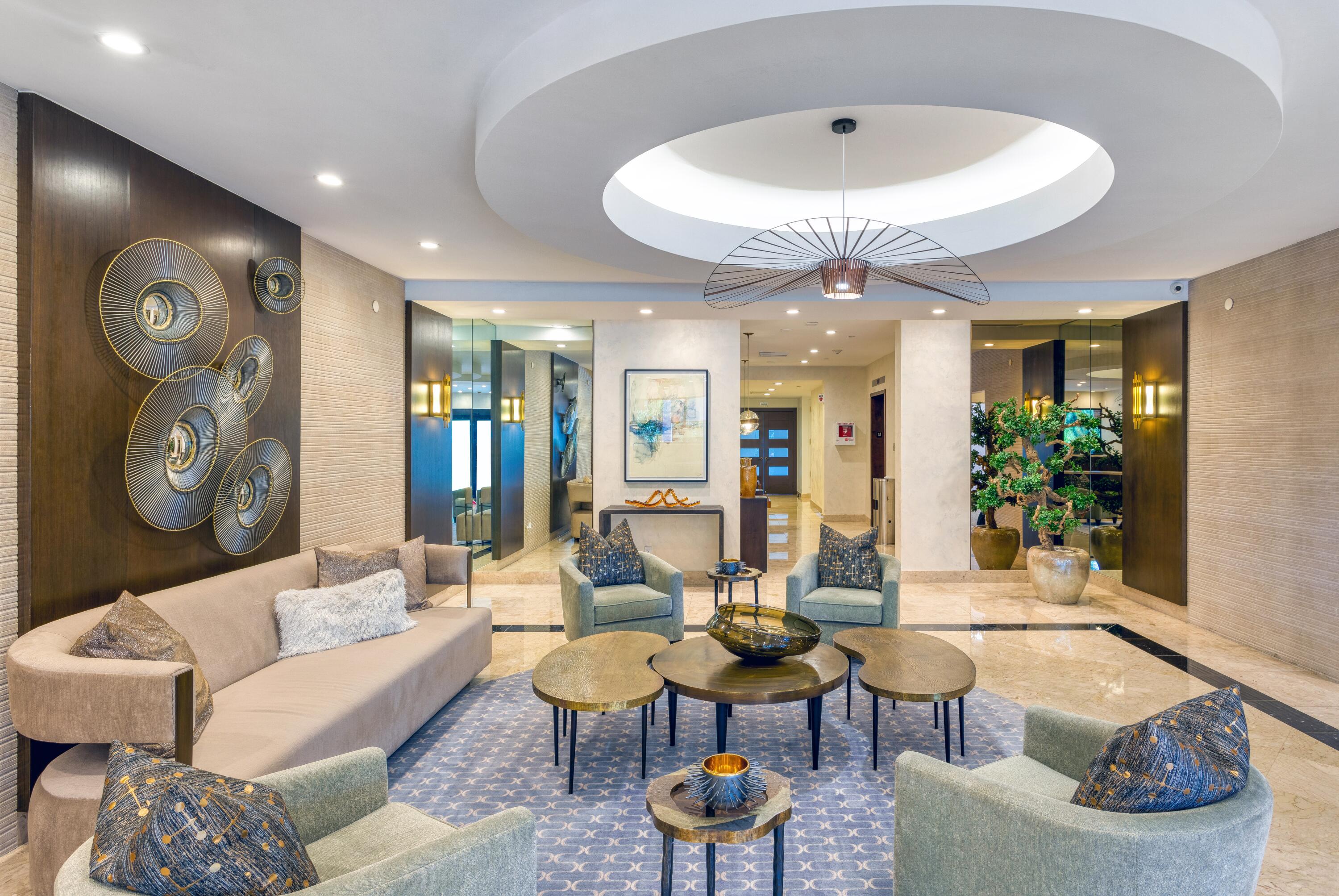 901 East Camino Real, Unit 7C Boca Raton, FL 33432 - Photo 35 of 41 a living room with furniture a chandelier and a large window