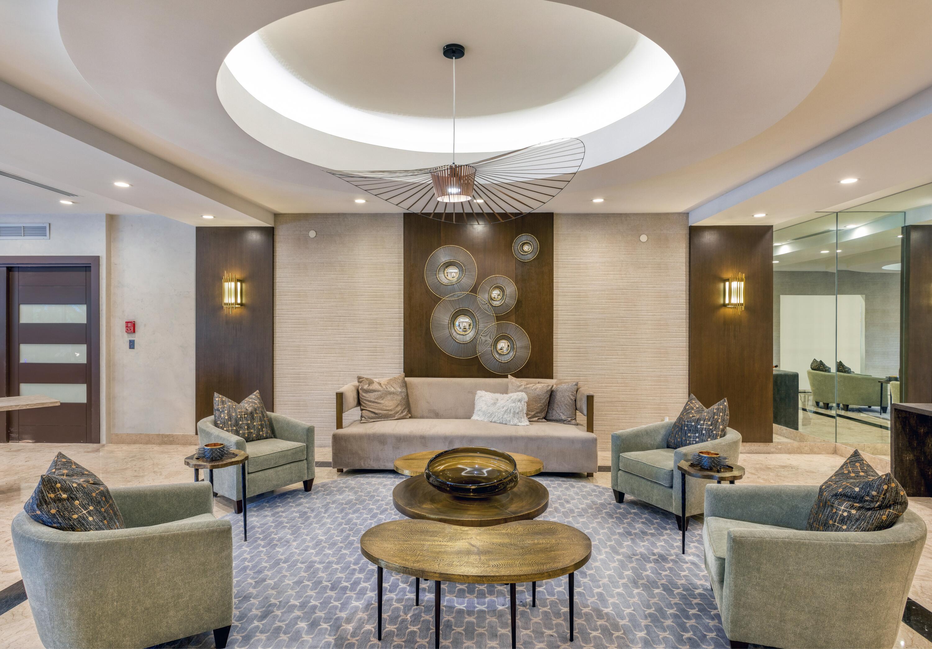 901 East Camino Real, Unit 7C Boca Raton, FL 33432 - Photo 36 of 41 a living room with furniture and a chandelier