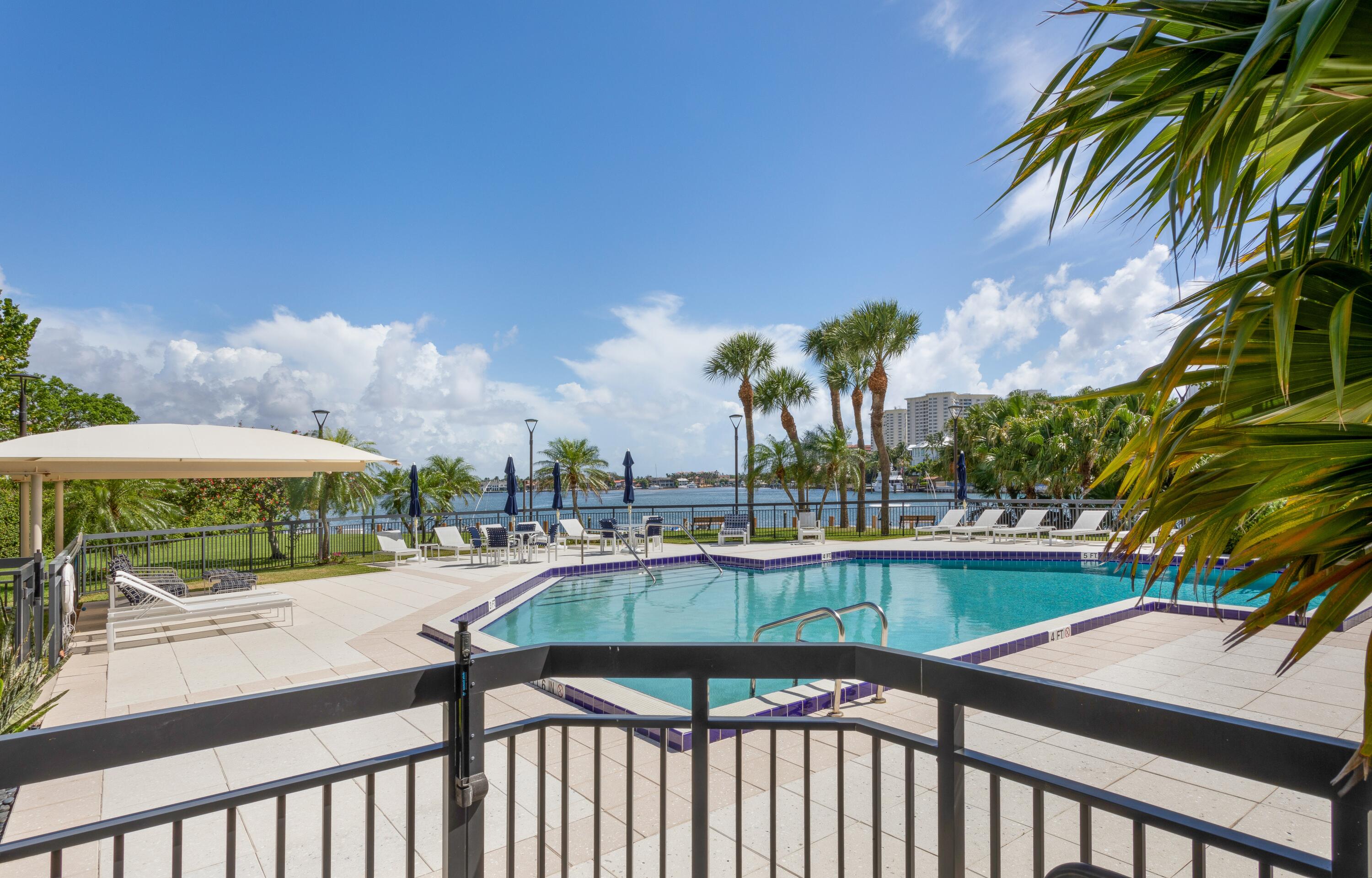 901 East Camino Real, Unit 7C Boca Raton, FL 33432 - Photo 38 of 41 a view of a swimming pool with a patio and a garden