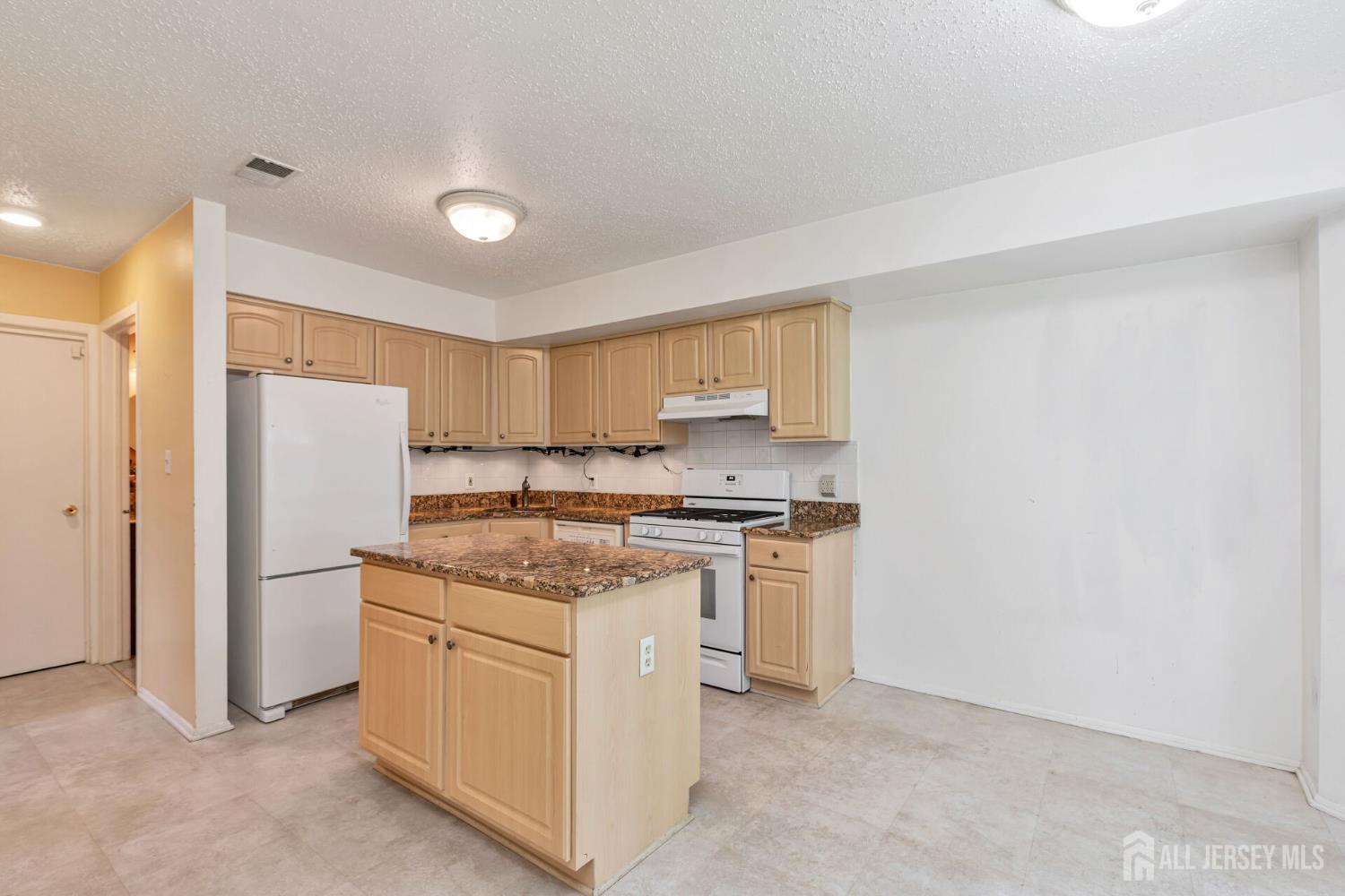 146 Nebula Road Piscataway, NJ 08854 - Photo 12 of 51 a kitchen with a stove a refrigerator and white cabinets
