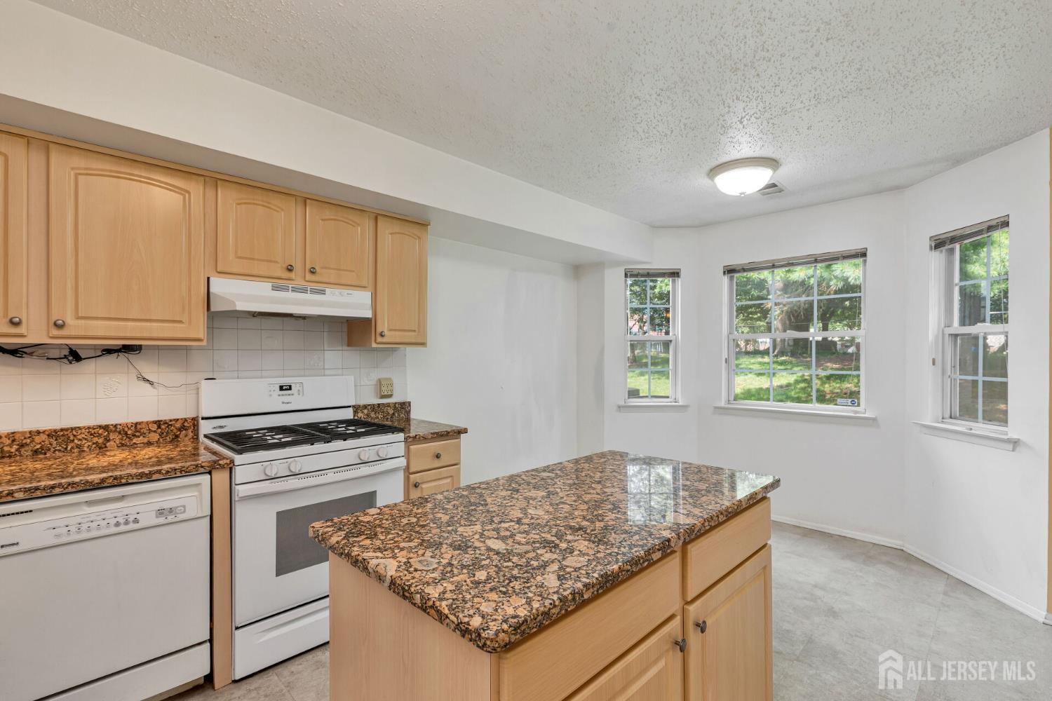 146 Nebula Road Piscataway, NJ 08854 - Photo 18 of 51 a kitchen with stainless steel appliances granite countertop a stove sink and cabinets