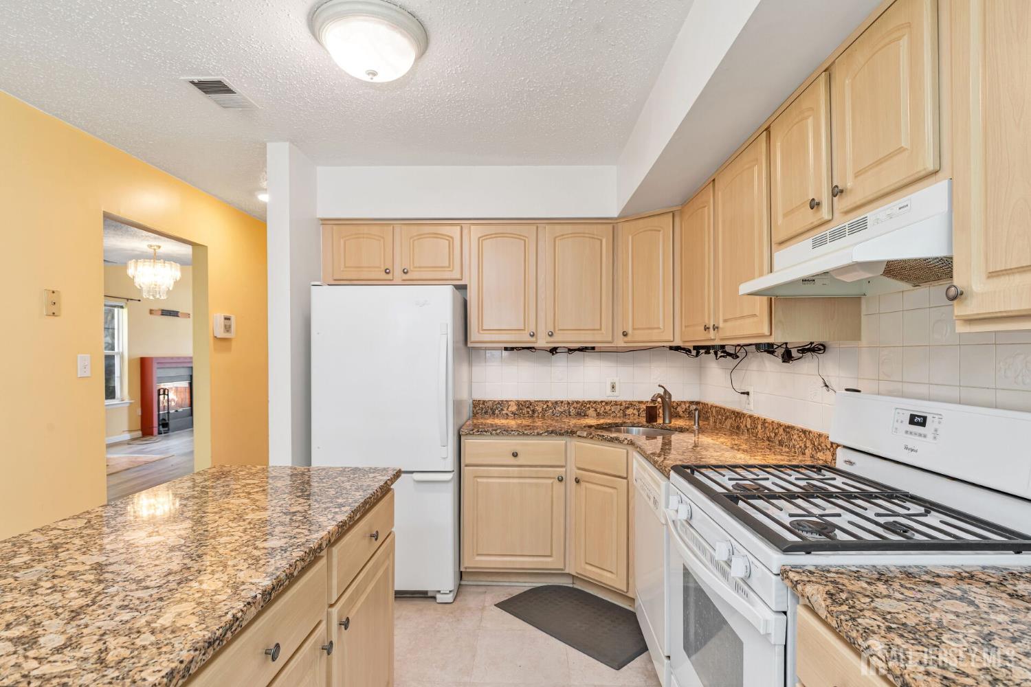 146 Nebula Road Piscataway, NJ 08854 - Photo 19 of 51 a kitchen with granite countertop a sink stove and cabinets