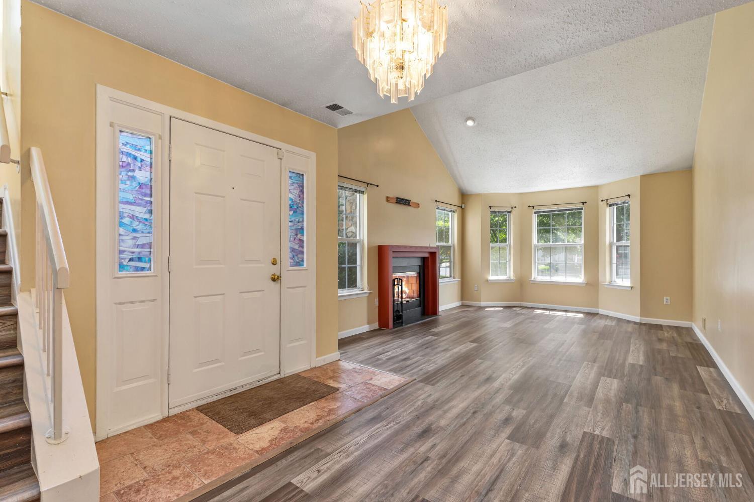 146 Nebula Road Piscataway, NJ 08854 - Photo 3 of 51 a view of an empty room with wooden floor and a window