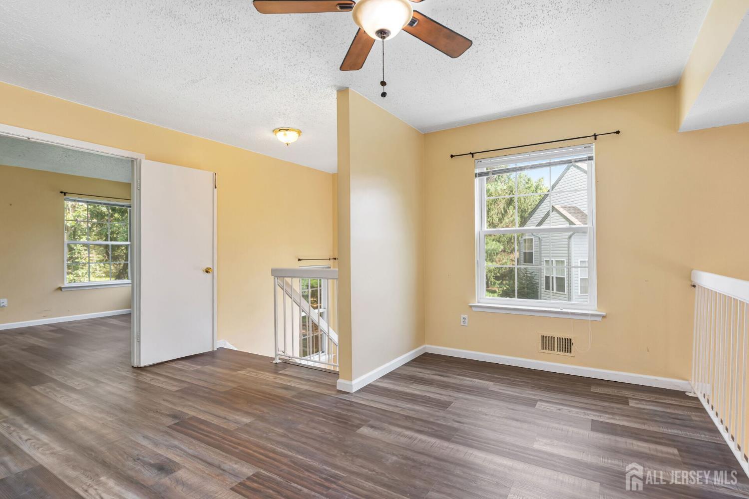 146 Nebula Road Piscataway, NJ 08854 - Photo 32 of 51 a view of an empty room with wooden floor and a window