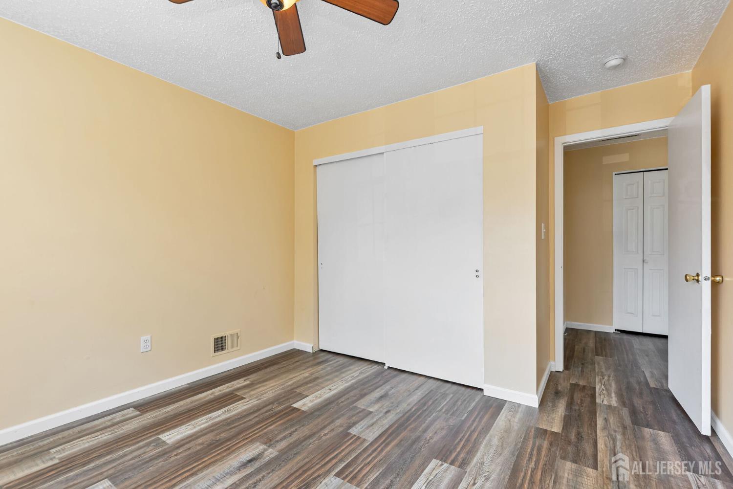 146 Nebula Road Piscataway, NJ 08854 - Photo 36 of 51 a view of a room with wooden floor a ceiling fan