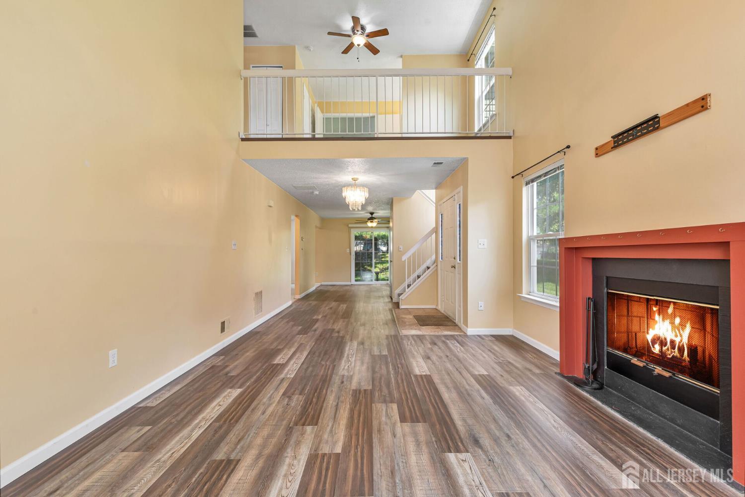146 Nebula Road Piscataway, NJ 08854 - Photo 8 of 51 a view of a livingroom with wooden floor and a fireplace