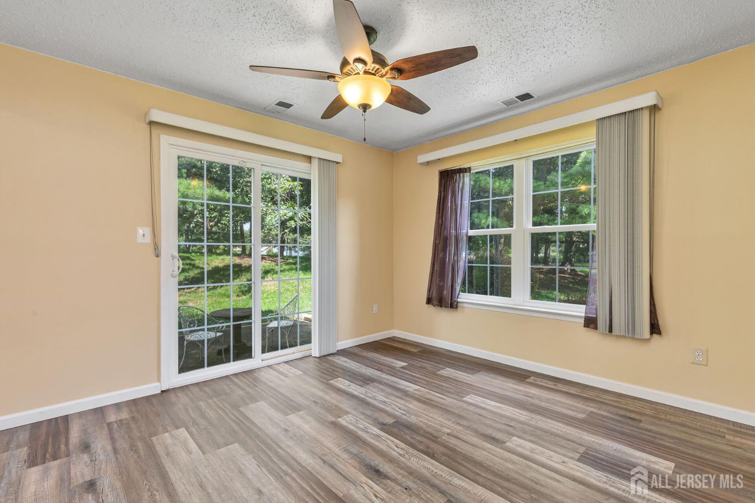146 Nebula Road Piscataway, NJ 08854 - Photo 10 of 51 a view of an empty room with a window and wooden floor