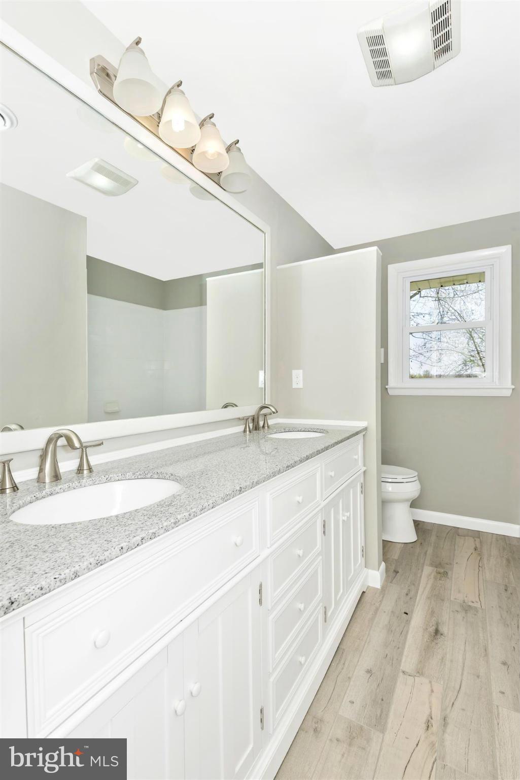 14723 Harrisville Road Mount Airy, MD 21771 - Photo 15 of 29 a bathroom with a granite countertop sink a toilet and a mirror