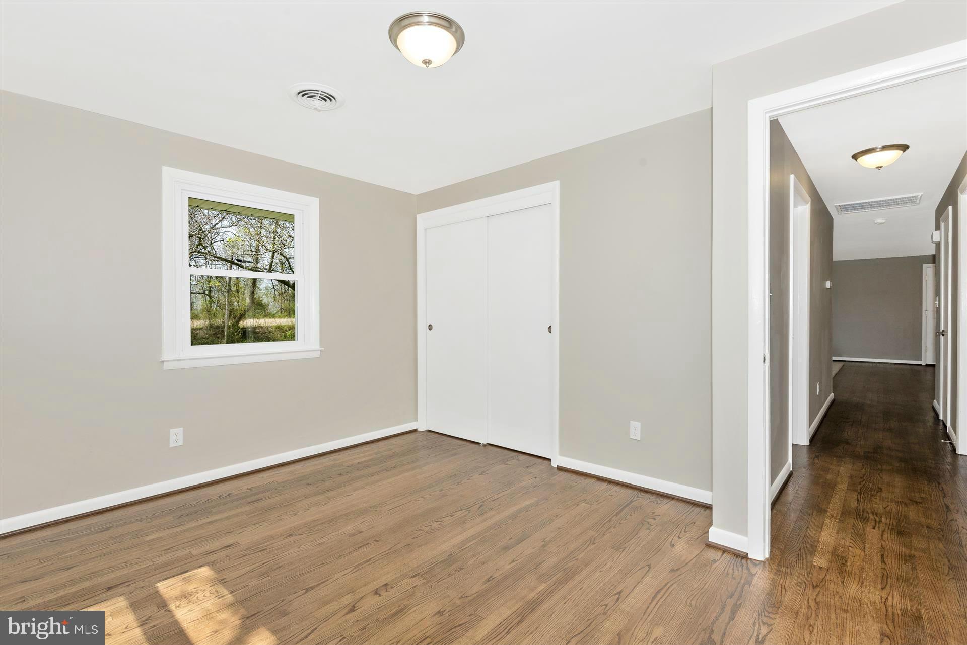 14723 Harrisville Road Mount Airy, MD 21771 - Photo 18 of 29 an empty room with wooden floor and windows