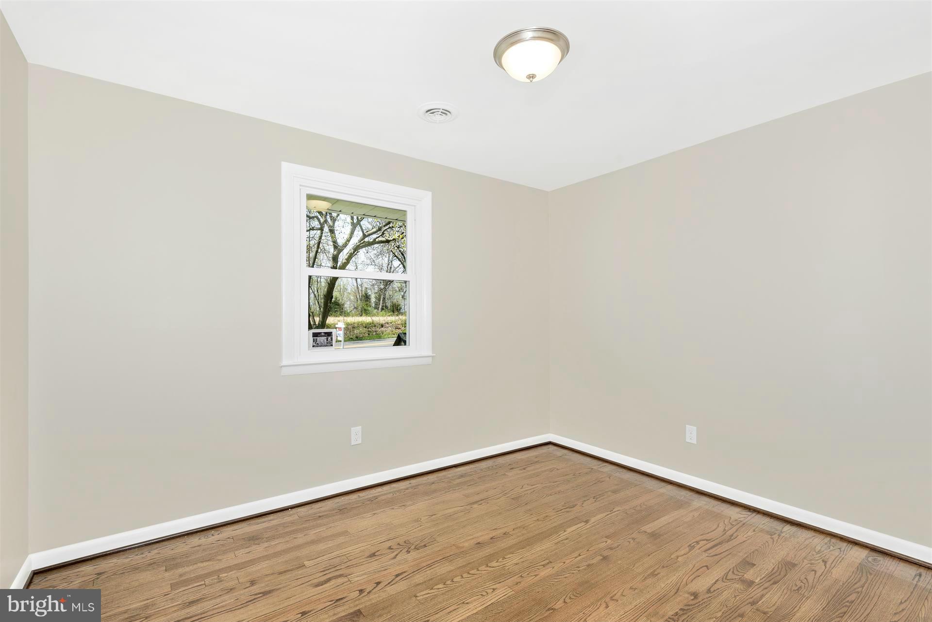 14723 Harrisville Road Mount Airy, MD 21771 - Photo 19 of 29 an empty room with wooden floor and windows
