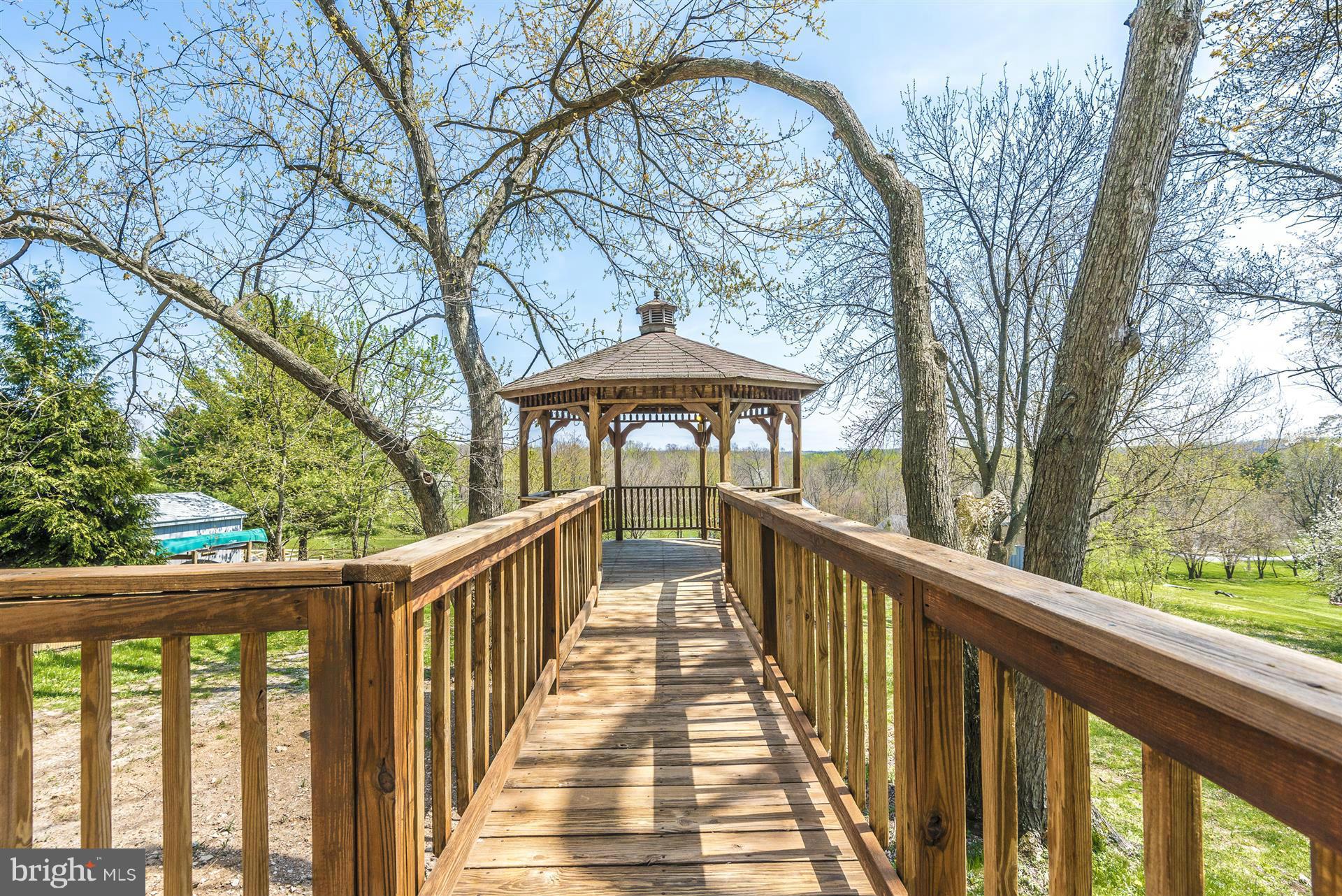 14723 Harrisville Road Mount Airy, MD 21771 - Photo 5 of 29 a view of a wooden deck next to a yard