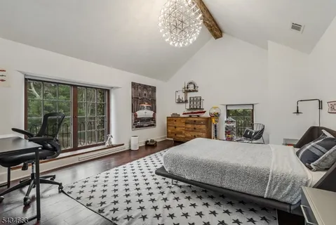 a bedroom with a bed a table and chair