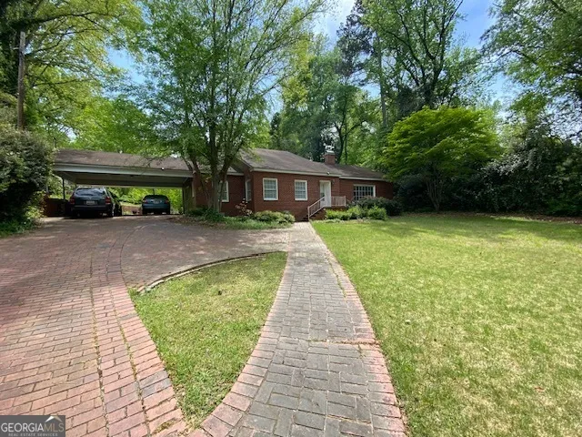 a front view of house with yard and green space