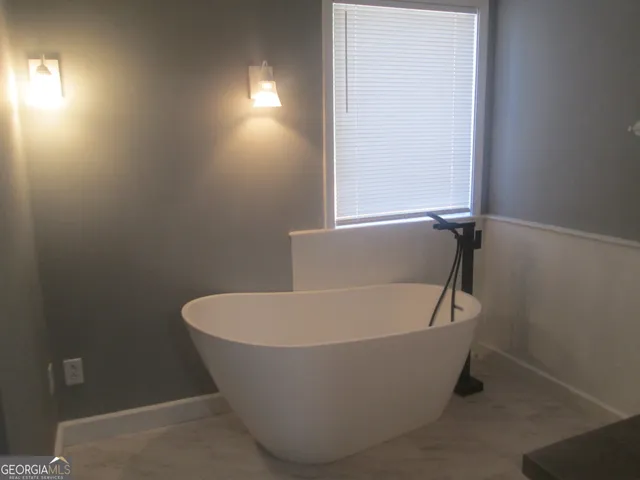 a white bath tub sitting in a bathroom