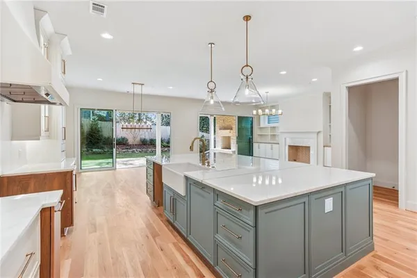 a view of counter top space with stainless steel appliances granite countertop furniture and wooden floor