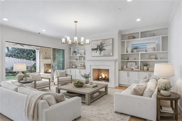 a living room with furniture fireplace and a large window