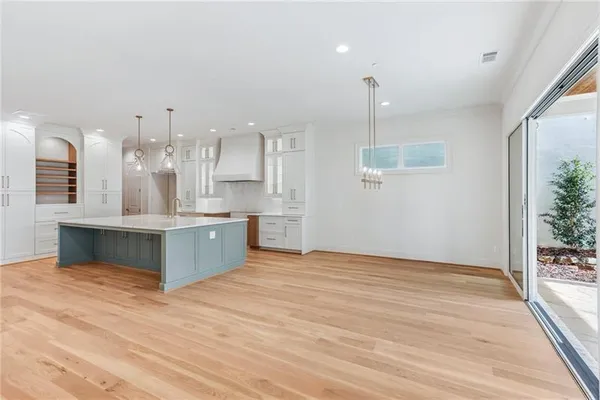 a large kitchen with kitchen island a sink stainless steel appliances and cabinets