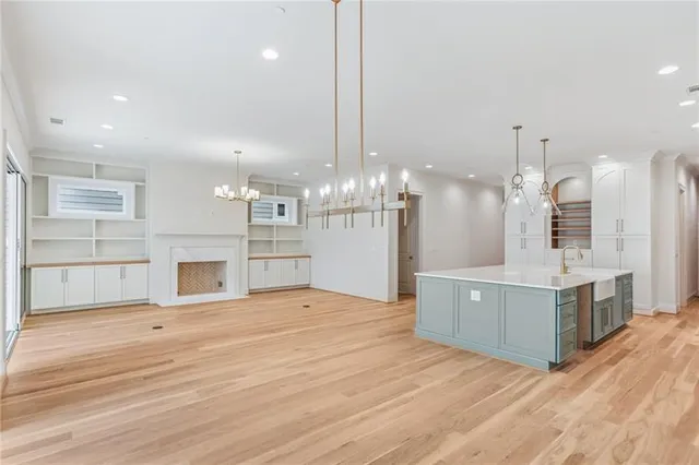a large kitchen with kitchen island a sink stainless steel appliances and cabinets