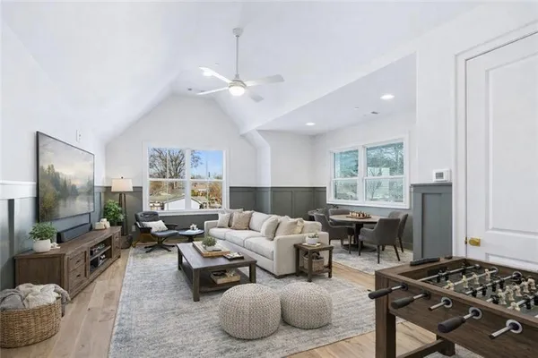 a living room with furniture a window and a flat screen tv