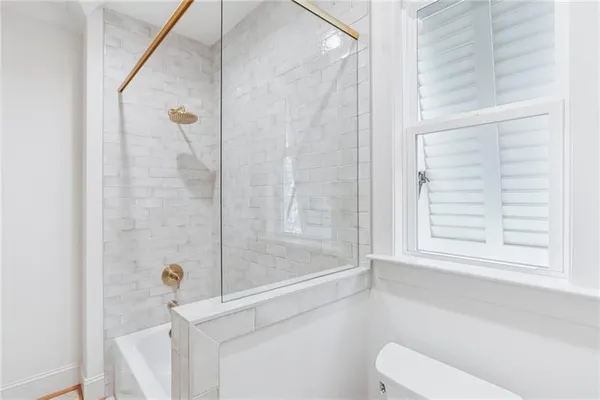 a bathroom with a shower and a toilet