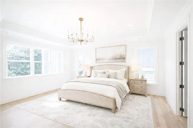 a bedroom with a bed and a chandelier