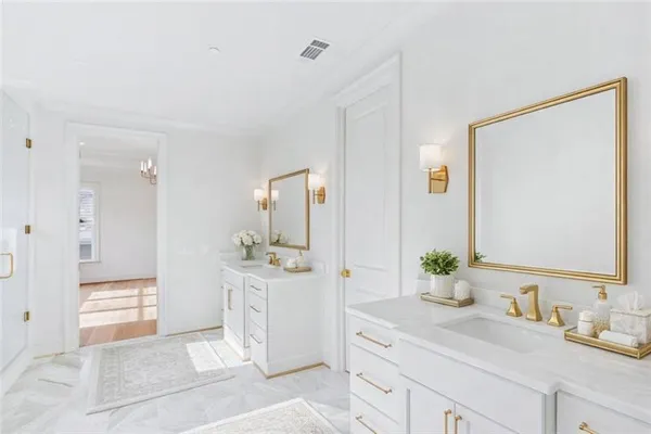a spacious bathroom with a granite countertop sink and a mirror