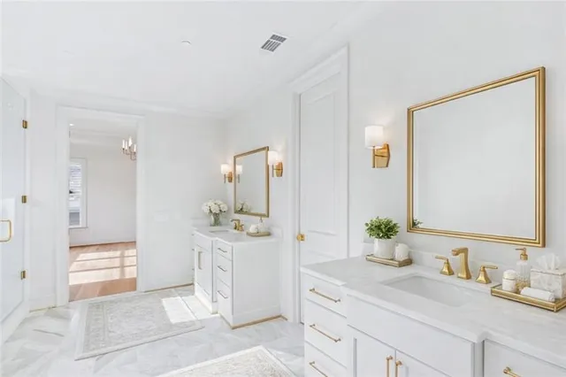 a spacious bathroom with a granite countertop sink and a mirror