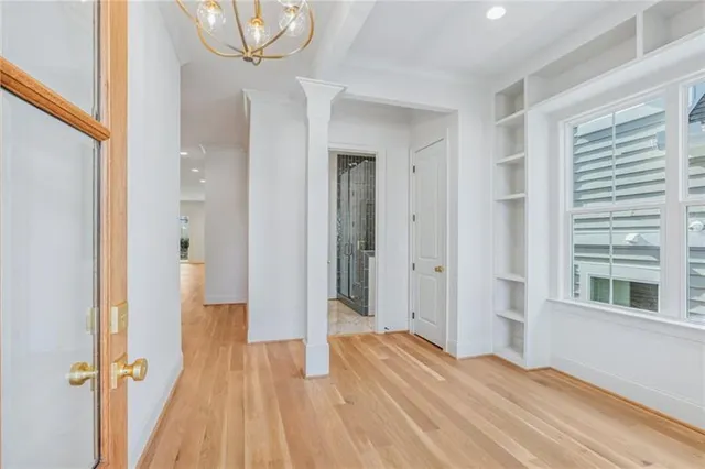a view of a room with wooden floor and a window