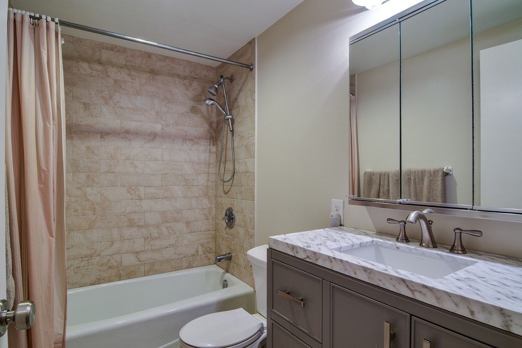 85 Algonquin Road, Unit 85 Chestnut Hill, MA 02467 - Photo 14 of 21 a bathroom with a granite countertop sink toilet and shower