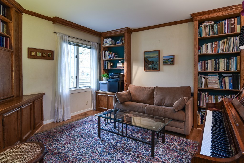 85 Algonquin Road, Unit 85 Chestnut Hill, MA 02467 - Photo 15 of 21 a living room with furniture and a book shelf