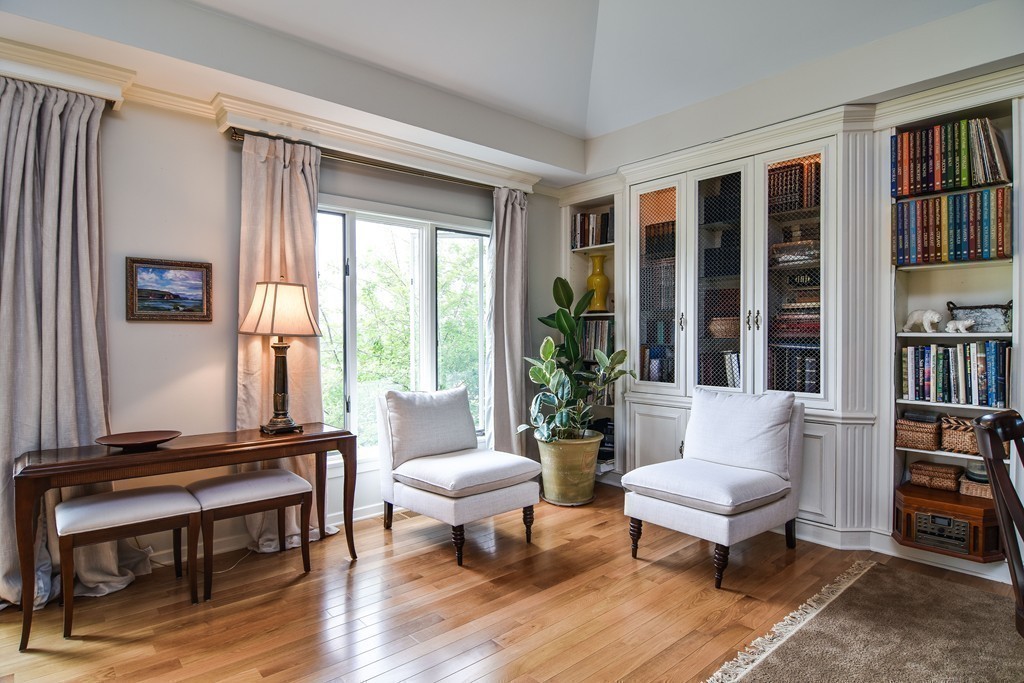 85 Algonquin Road, Unit 85 Chestnut Hill, MA 02467 - Photo 4 of 21 a living room with furniture a bookshelf and a window