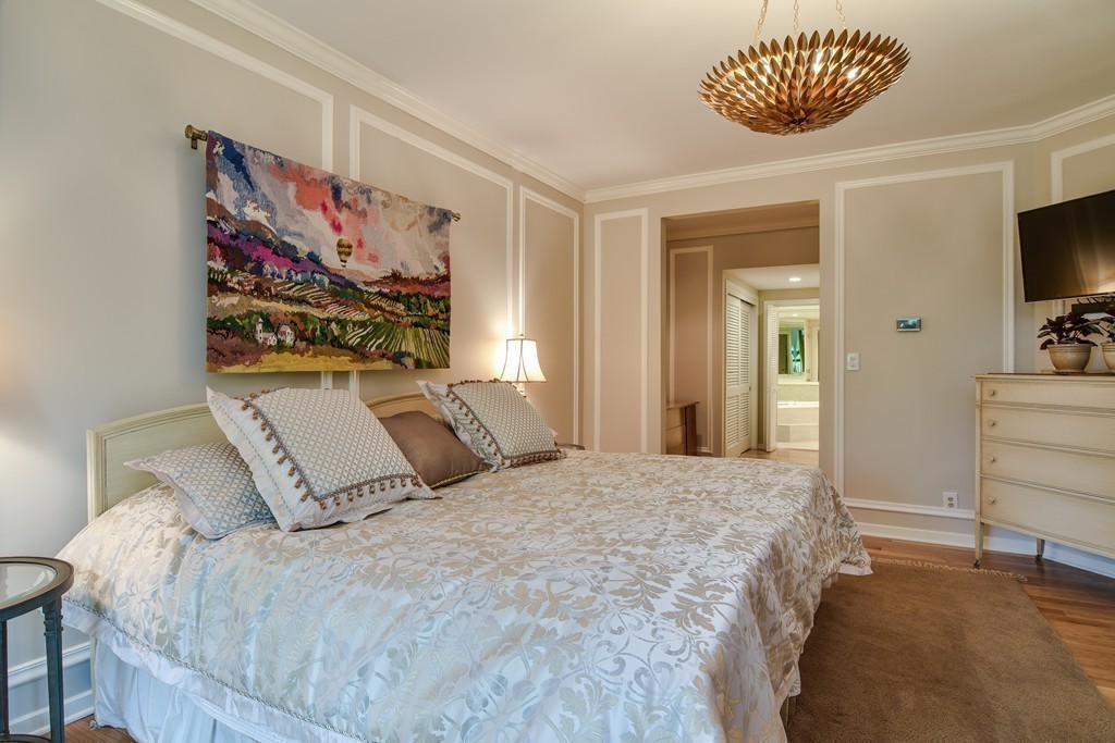 85 Algonquin Road, Unit 85 Chestnut Hill, MA 02467 - Photo 9 of 21 a bedroom with a bed and a painting on the wall