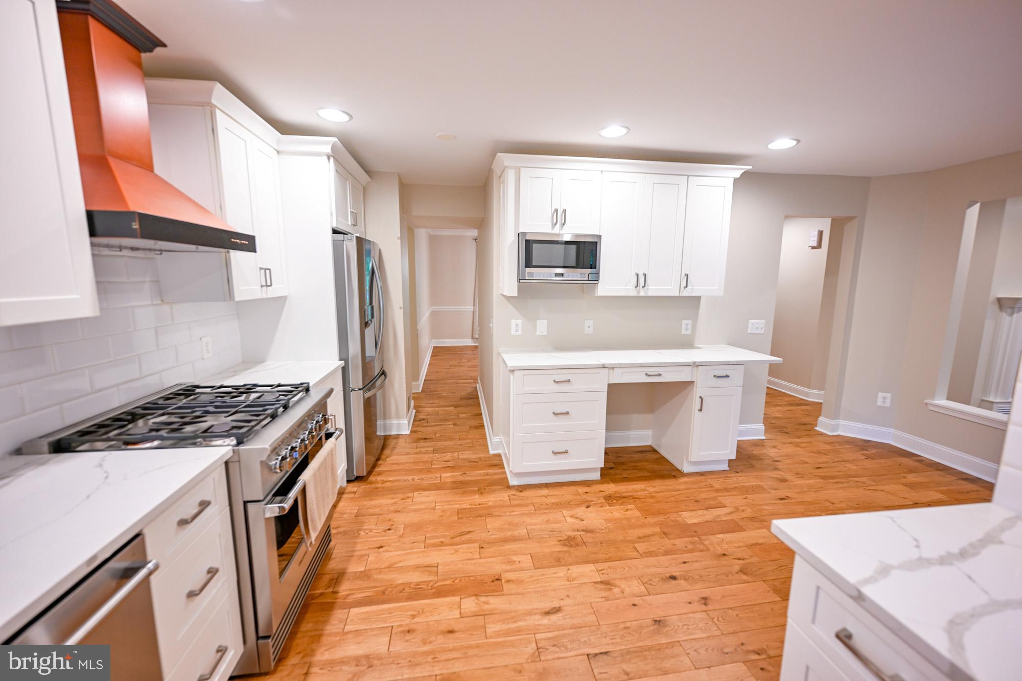 622 Hastings Road Baltimore, MD 21286 - Photo 25 of 87 a kitchen with stainless steel appliances granite countertop a stove top oven a sink a refrigerator and white cabinets