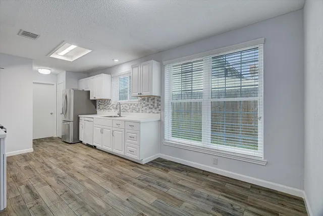 a view of a kitchen with wooden floor