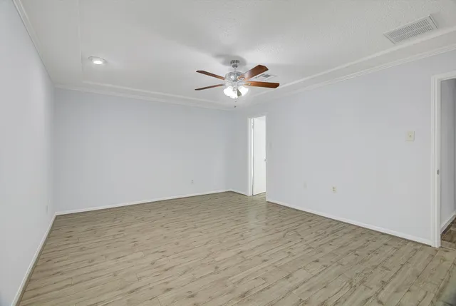 a view of an empty room with a ceiling fan