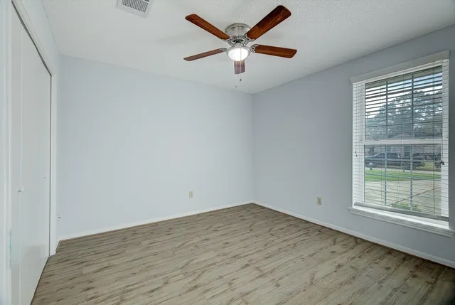 wooden floor in an empty room with a window