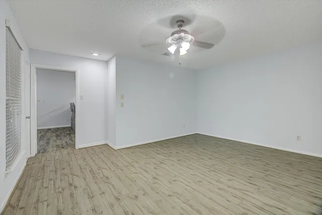 a view of an empty room and wooden floor