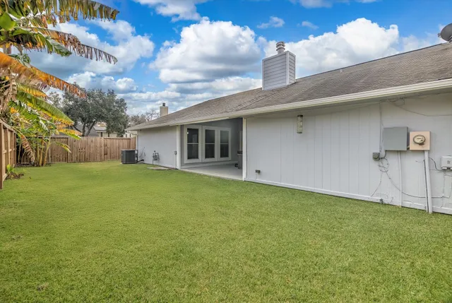 a backyard of a house with table and chairs