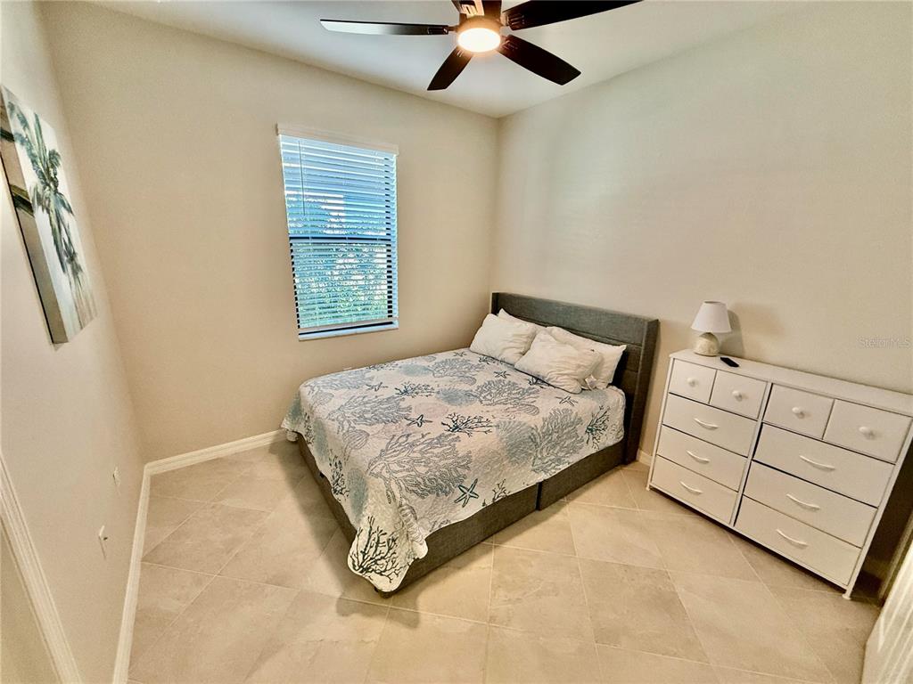 10852 Sun Drop Street Venice, FL 34293 - Photo 9 of 15 a bedroom with a bed and a window