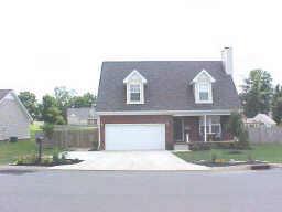 1952 Portway Road Spring Hill, TN 37174 - Photo 1 of 12 a front view of a house with a yard and garage