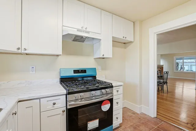 a kitchen with cabinets and a stove top oven