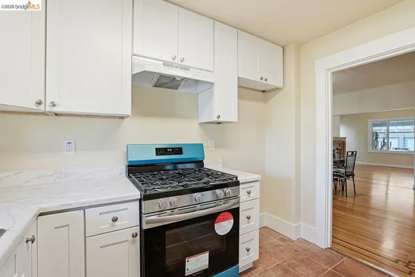 a kitchen with cabinets and a stove top oven