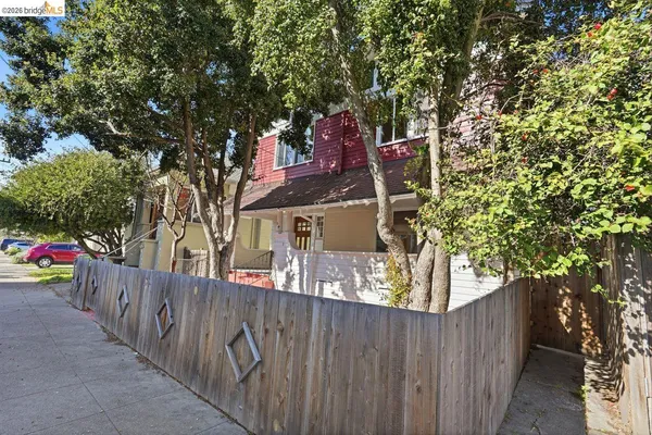 a view of a house with wooden fence