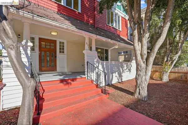 a view of a house with wooden fence