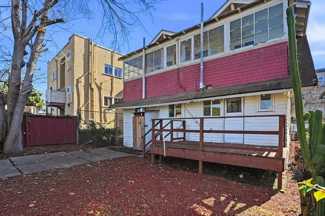 a view of a house with a yard and sitting area