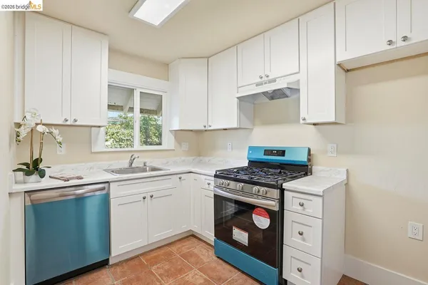a kitchen with stainless steel appliances granite countertop a sink stove and cabinets