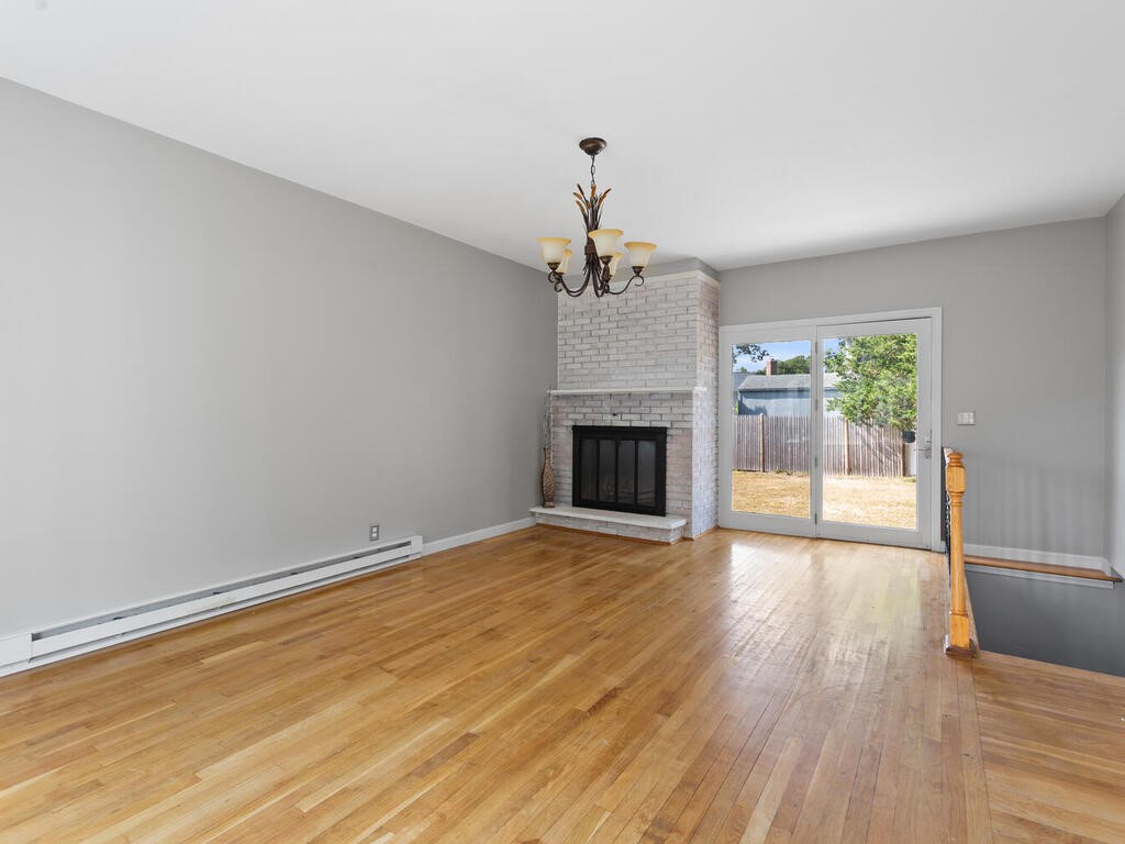 147 Moccasin Drive Warwick, RI 02889 - Photo 4 of 32 Conversion living room with fireplace, could be dining area or media room