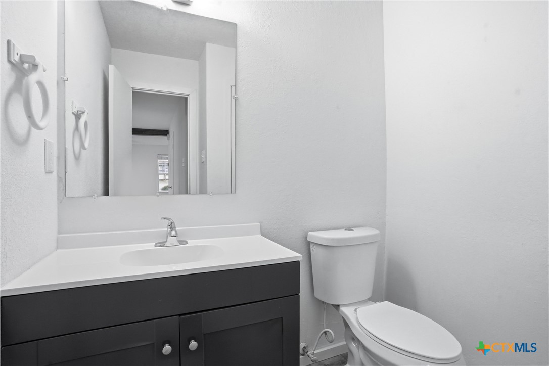 922 North 7th Street Copperas Cove, TX 76522 - Photo 15 of 26 a bathroom with a sink a toilet and mirror